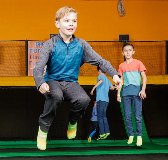 Boy jumping on trampoline at Rockin Jump