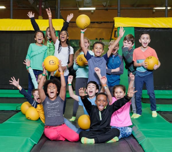 Group of children holding dodgeballs at Rockin Jump